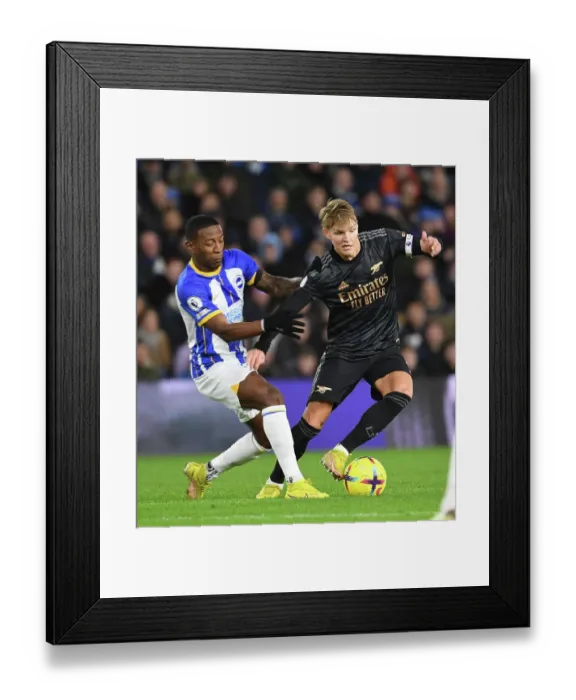 Framed Print : Arsenal's Martin Odegaard Outmaneuvers Brighton's Pervis Estupinan in Premier League Clash