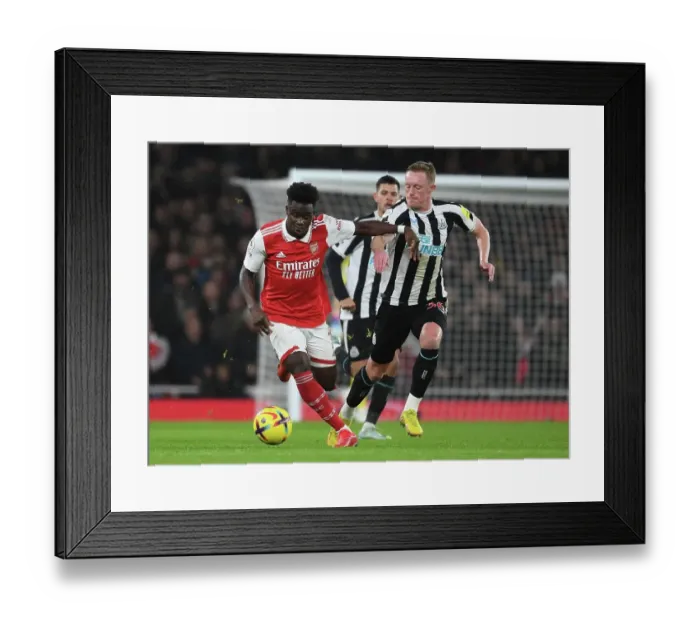 Framed Print : Saka's Skillful Run: Outsmarting Longstaff in Arsenal's Premier League Victory Framed Print : Saka's Skillful Run: Outsmarting Longstaff in Arsenal's Premier League Victory