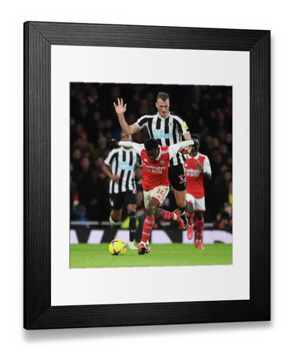 Framed Print : Arsenal vs Newcastle: Nketiah Fouls by Burn in Intense Premier League Clash (2022-23) Framed Print : Arsenal vs Newcastle: Nketiah Fouls by Burn in Intense Premier League Clash (2022-23)