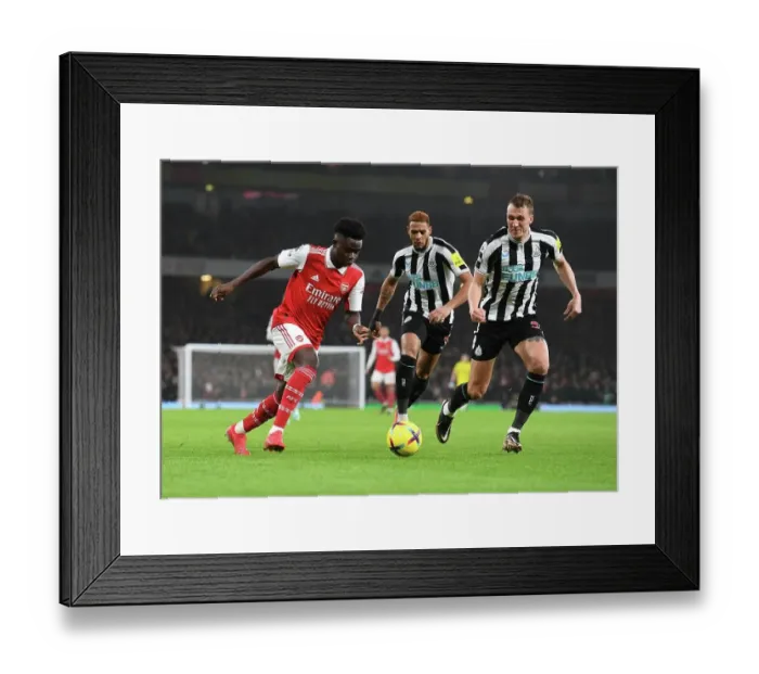 Framed Print : Arsenal's Bukayo Saka Outwits Newcastle's Dan Burn: A Premier League Tactical Battle Framed Print : Arsenal's Bukayo Saka Outwits Newcastle's Dan Burn: A Premier League Tactical Battle