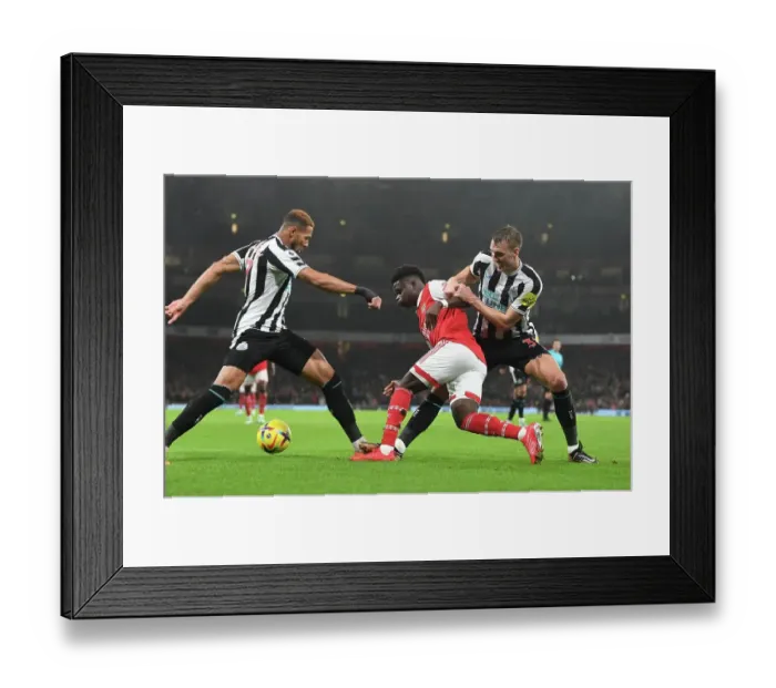 Framed Print : Arsenal's Bukayo Saka Overpowers Newcastle's Defense: Intense Battle against Joelinton and Dan Burn, 2023 Framed Print : Arsenal's Bukayo Saka Overpowers Newcastle's Defense: Intense Battle against Joelinton and Dan Burn, 2023