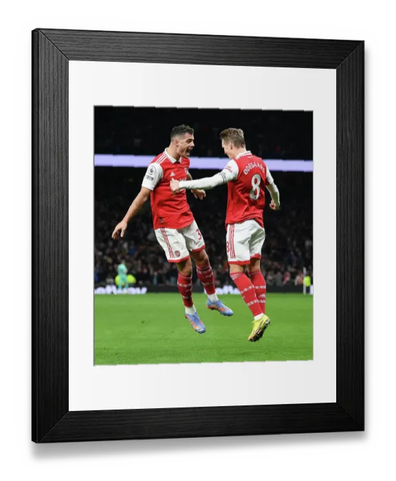 Framed Print : Martin Odegaard and Granit Xhaka Celebrate Arsenal's Winning Goal Against Tottenham Hotspur (2022-23)
