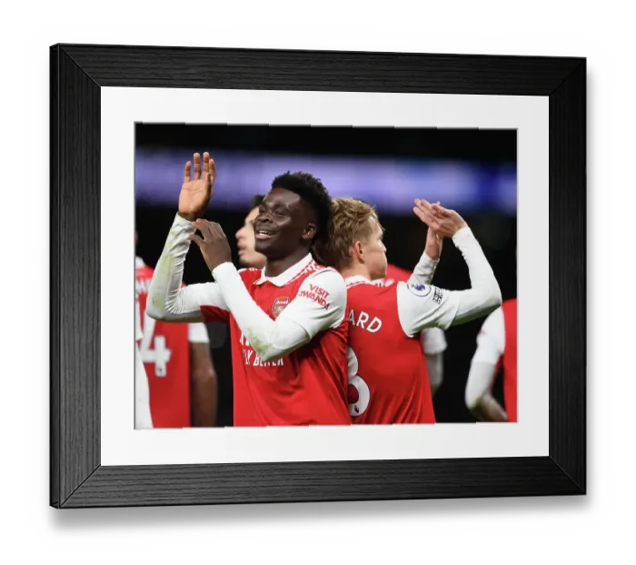 Framed Print : Arsenal's Unstoppable Duo: Martin Odegaard and Bukayo Saka Celebrate Goal Against Tottenham in the 2022-23 Premier League