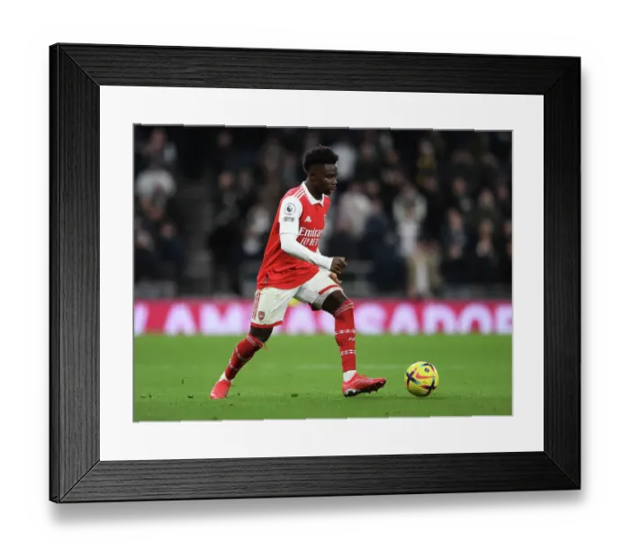 Framed Print : Bukayo Saka Goes Head-to-Head with Tottenham Hotspur in Intense Premier League Showdown Framed Print : Bukayo Saka Goes Head-to-Head with Tottenham Hotspur in Intense Premier League Showdown