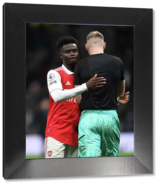 Arsenal's Bukayo Saka and Aaron Ramsdale Celebrate Victory over Tottenham Hotspur in 2022-23 Premier League Clash
