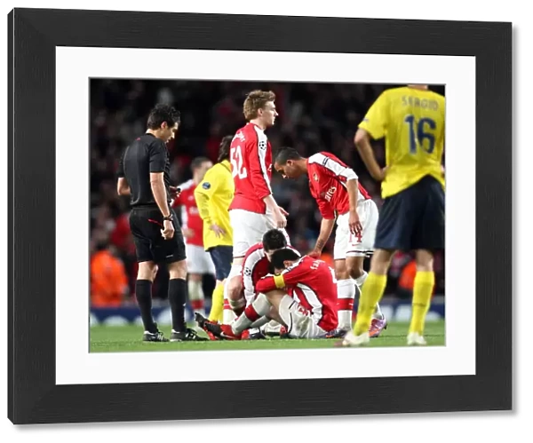 Cesc Fabregas (Arsenal) sits on the floor injured having just scored Arsenals 2nd goal