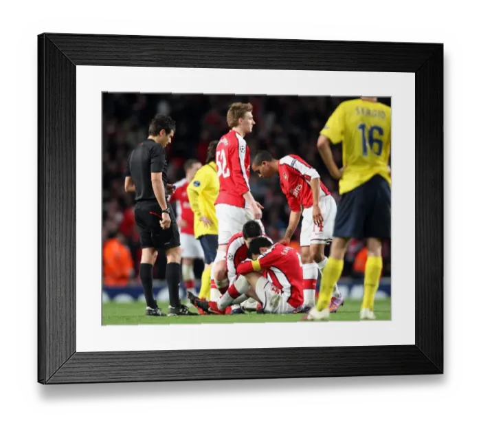 Framed Print : Cesc Fabregas (Arsenal) sits on the floor injured having just scored Arsenals 2nd goal