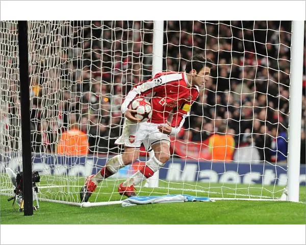 Cesc Fabregas picks up the matchball after scoring the 2nd Arsenal goal