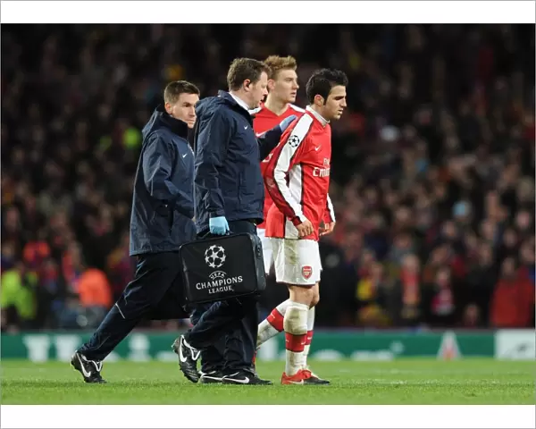 Injured Arsenal captain Cesc Fabregas limps off the pitch. Arsenal 2: 2 Barcelona