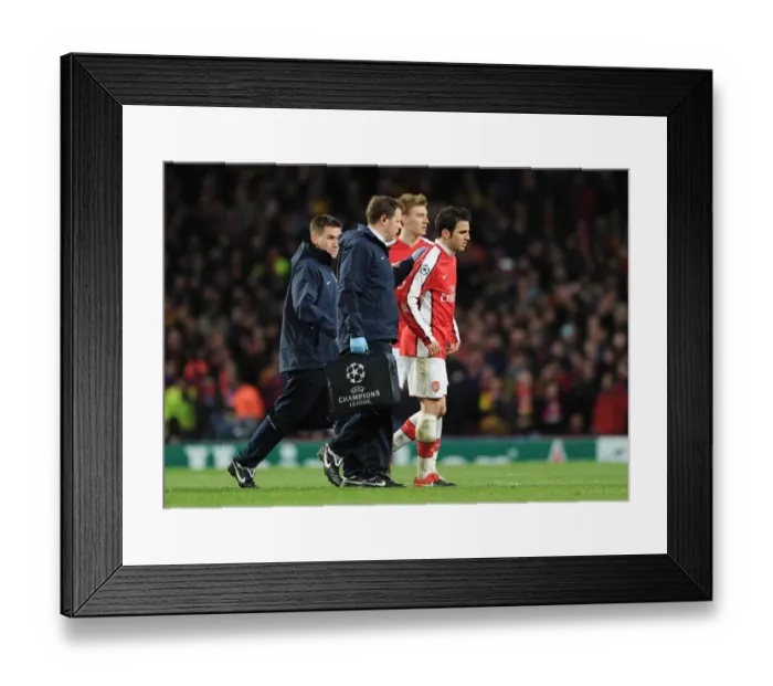 Framed Print : Injured Arsenal captain Cesc Fabregas limps off the pitch. Arsenal 2: 2 Barcelona