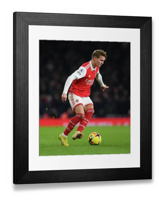 Framed Print : Martin Odegaard vs Manchester United: Arsenal's Midfield Maestro Clashes with Rivals in Premier League Battle (2022-23)