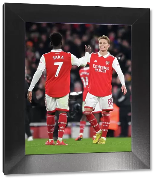 Arsenal's Odegaard and Saka Celebrate Victory Over Manchester United in 2022-23 Premier League