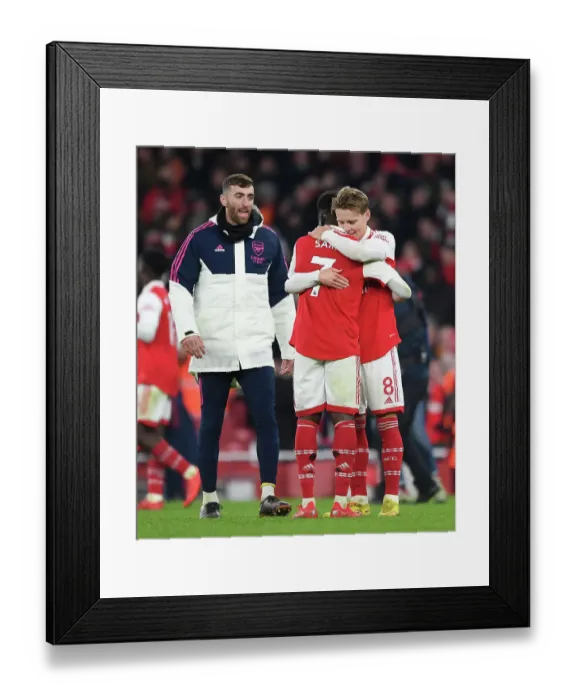 Framed Print : Arsenal: Odegaard and Saka Embrace Victory After Beating Manchester United