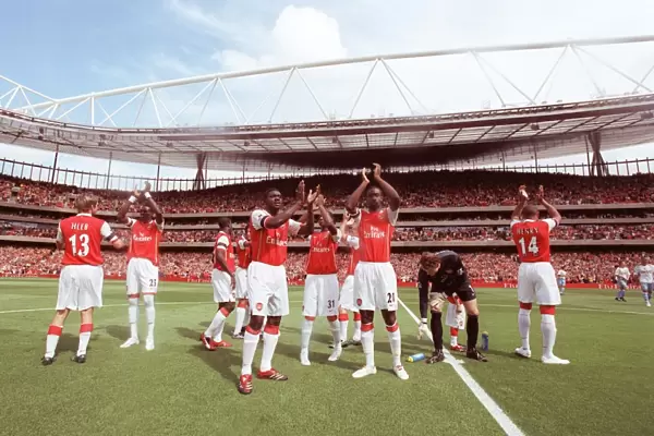 Kolo Toure and Johan Djourou (Arsenal) clap the fans along with the rest of the team