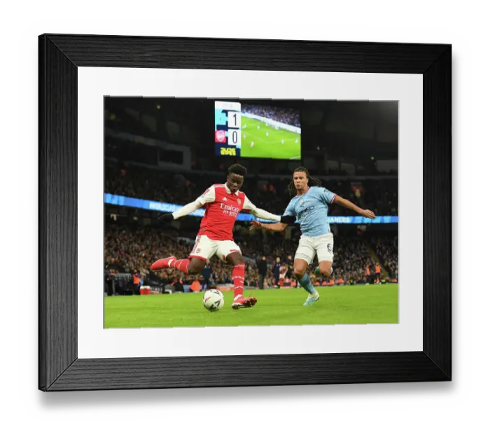 Framed Print : Bukayo Saka vs. Nathan Ake: Clash of the Stars in Manchester City vs. Arsenal FA Cup Match, 2023