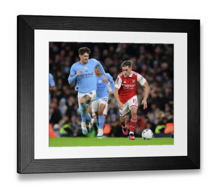 Framed Print : Arsenal's Trossard Clashes with Man City's Stones in FA Cup Showdown
