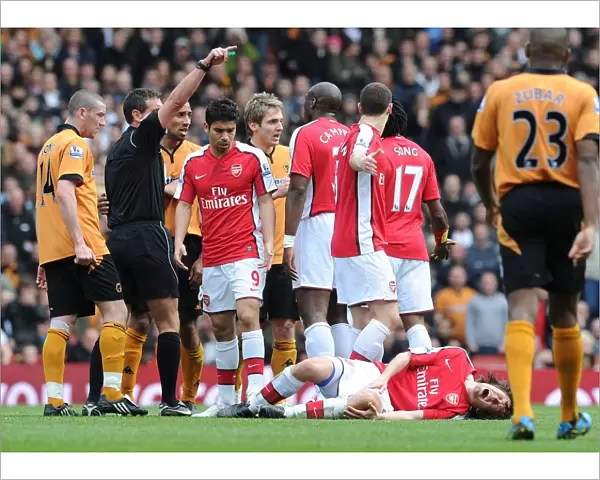 Tomas Rosicky (Arsenal) injured after a challenge from Wolves captain Carl Henry