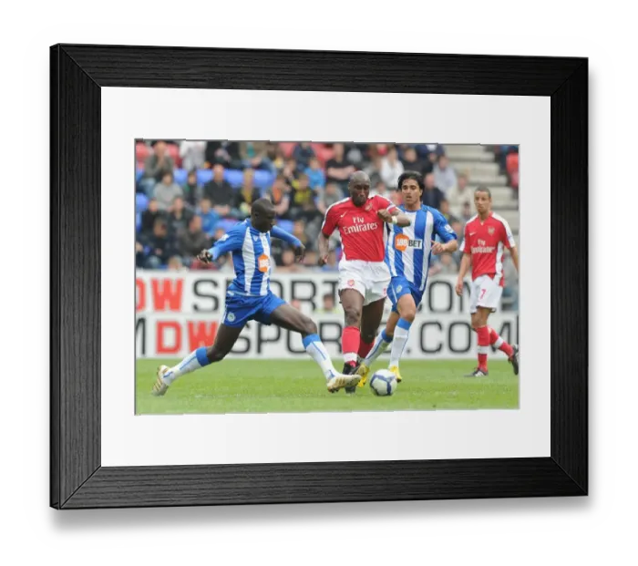 Framed Print : Sol Campbell vs. Mohamed Diame: Wigan Athletic's Upset Over Arsenal in FA Premier League (3-2) Framed Print : Sol Campbell vs. Mohamed Diame: Wigan Athletic's Upset Over Arsenal in FA Premier League (3-2)