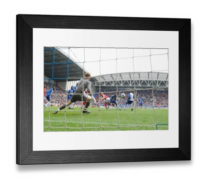 Framed Print : Mikael Silvestre heads past Wigan goalkeeper Chris Kirkland to score the 2nd Arsenal goal