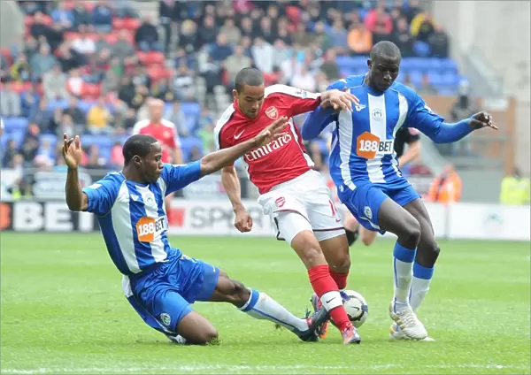Theo Walcott (Arsenal) Maynor Figueroa and Mohamed Diame (Wigan). Wigan Athletic 3