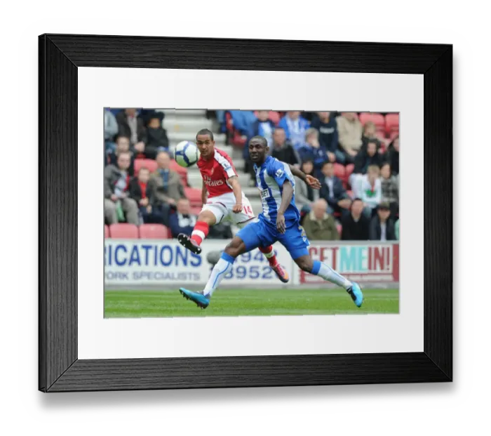 Framed Print : Theo Walcott (Arsenal) Steve Gohouri (Wigan). Wigan Athletic 3: 2 Arsenal