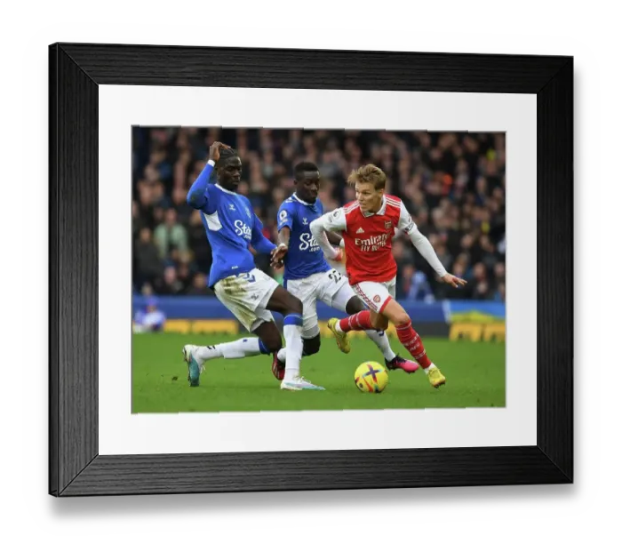 Framed Print : Arsenal's Martin Odegaard Clashes with Everton's Amadou Onana in Premier League Showdown Framed Print : Arsenal's Martin Odegaard Clashes with Everton's Amadou Onana in Premier League Showdown