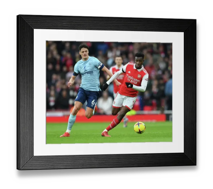 Framed Print : Arsenal's Eddie Nketiah Faces Off Against Brentford's Christian Norgaard in Premier League Clash at Emirates Stadium