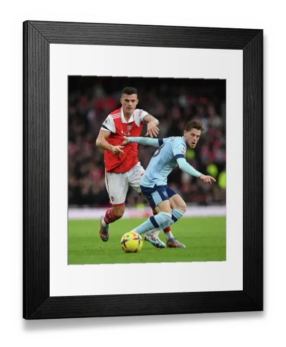 Framed Print : Intense Rivalry: Xhaka vs. Jensen - Arsenal vs. Brentford's Premier League Showdown