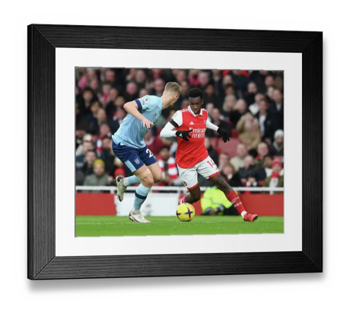 Framed Print : Intense Battle: Nketiah vs. Ajer in Arsenal's Premier League Clash Against Brentford Framed Print : Intense Battle: Nketiah vs. Ajer in Arsenal's Premier League Clash Against Brentford