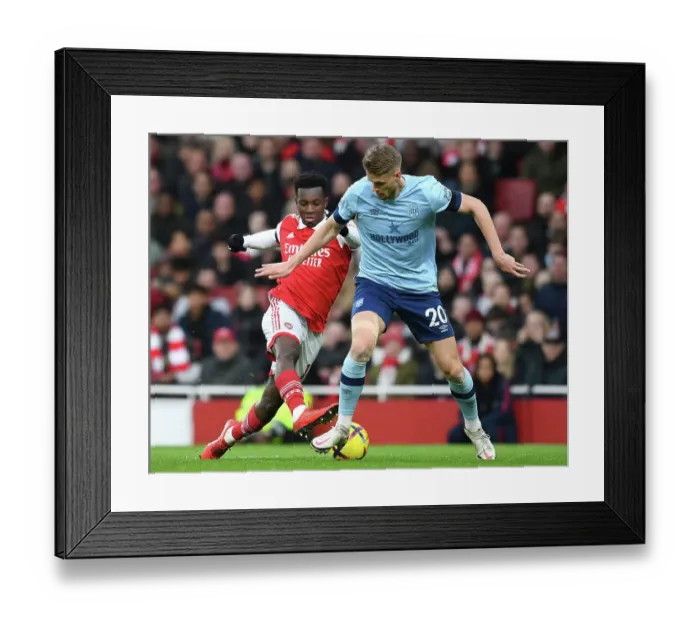 Framed Print : Arsenal's Eddie Nketiah Clashes with Brentford's Kristoffer Ajer in Premier League Showdown at Emirates Stadium