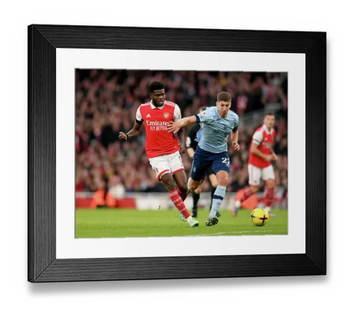 Framed Print : Arsenal's Thomas Partey Fends Off Pressure from Brentford's Vitaly Roerslev During Premier League Clash