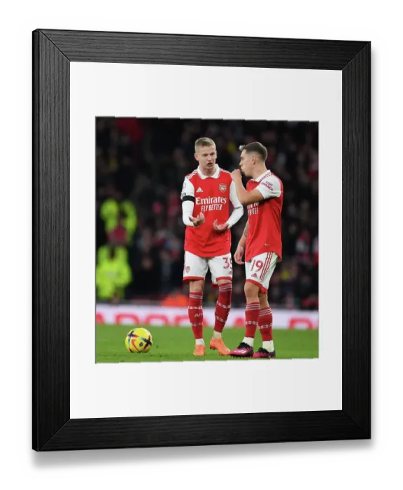 Framed Print : Arsenal's Zinchenko and Trossard Clash in Arsenal v Brentford Premier League Showdown