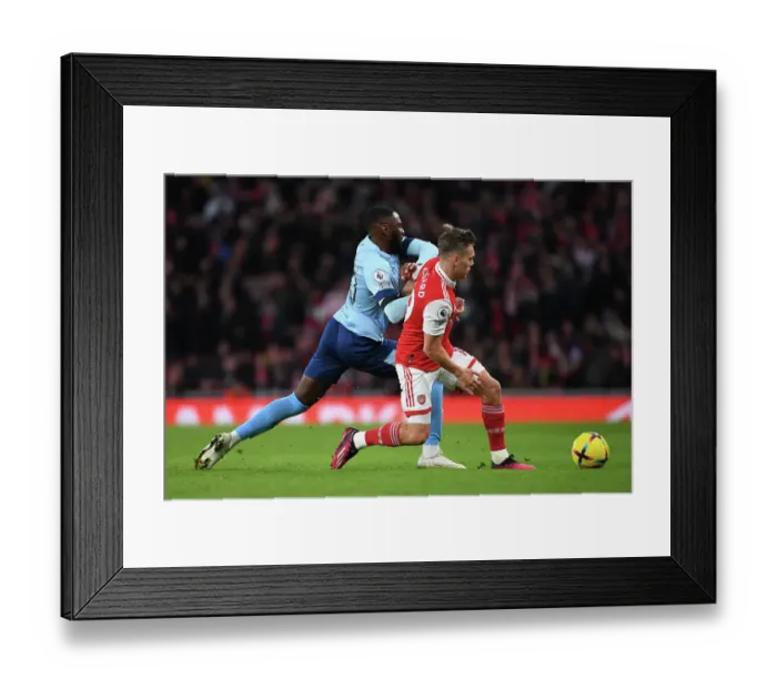 Framed Print : Arsenal vs. Brentford: Trossard and Dasilva Clash in Intense Premier League Match
