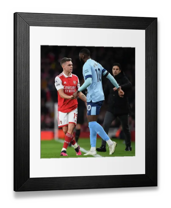 Framed Print : Arsenal vs. Brentford: Trossard and Dasilva Battle it Out in Premier League Showdown