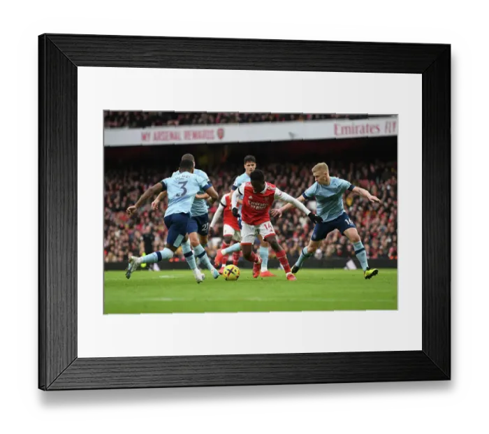 Framed Print : Arsenal's Eddie Nketiah Clashes with Brentford's Ben Mee and Rico Henry in Premier League Showdown