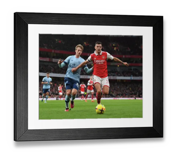 Framed Print : Arsenal's Xhaka Clashes with Brentford's Roerslev in Premier League Showdown