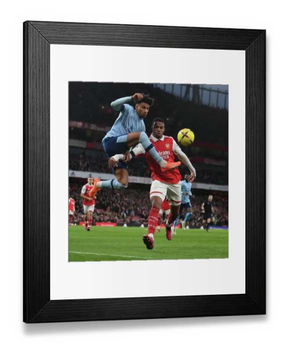 Framed Print : Arsenal vs Brentford: Gabriel Faces Off Against Schade in Intense Premier League Clash