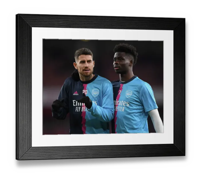 Framed Print : Saka vs. Jorginho: A Premier League Showdown - Arsenal's Young Star Clashes with Manchester City's Midfield Maestro