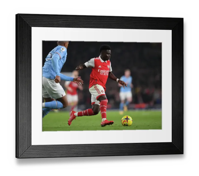 Framed Print : Bukayo Saka vs Manchester City: Arsenal's Rising Star Clashes with Premier League Titans