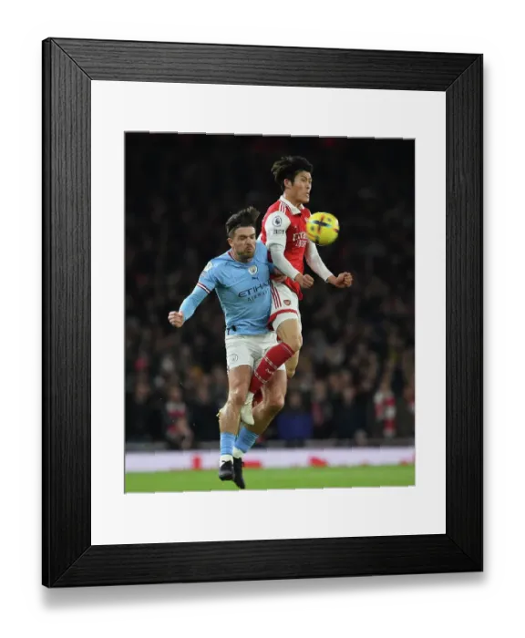 Framed Print : Arsenal vs Manchester City: Tomiyasu vs Grealish Clash in Premier League Showdown