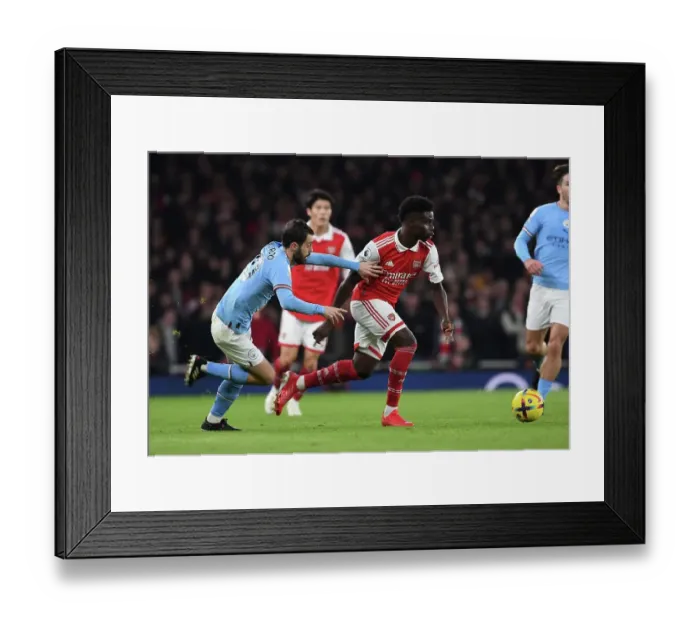 Framed Print : Arsenal's Bukayo Saka Clashes with Manchester City's Ilkay Gundogan in Premier League Showdown Framed Print : Arsenal's Bukayo Saka Clashes with Manchester City's Ilkay Gundogan in Premier League Showdown