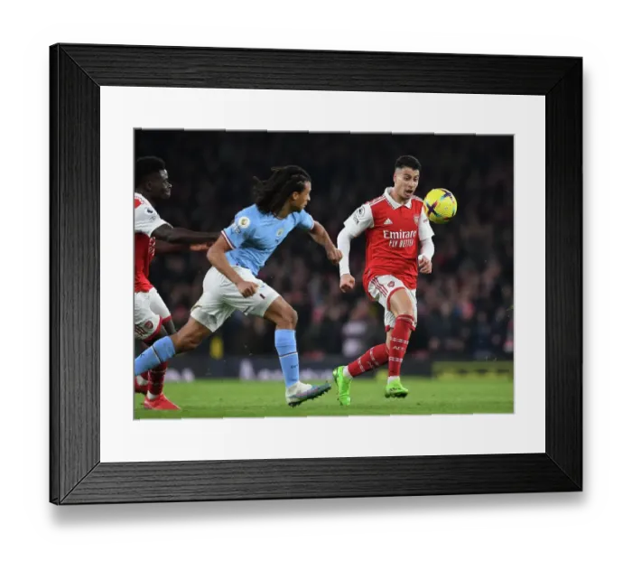 Framed Print : Martinelli vs Ake: A Fighting Spirit in Arsenal's Battle Against Manchester City
