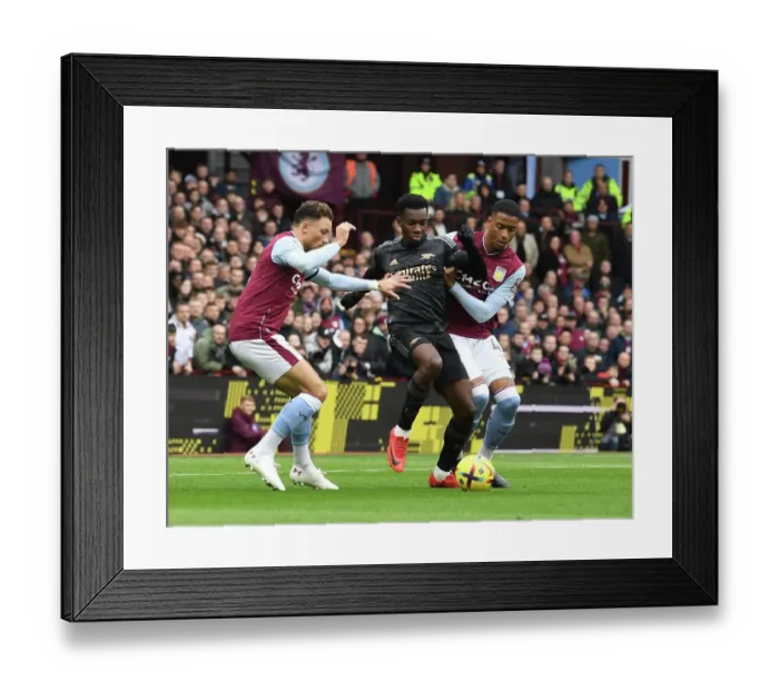 Framed Print : Arsenal's Eddie Nketiah Fends Off Aston Villa Defenders During Premier League Clash Framed Print : Arsenal's Eddie Nketiah Fends Off Aston Villa Defenders During Premier League Clash