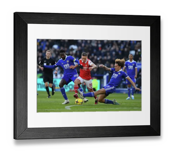 Framed Print : Leandro Trossard Faces Off Against Faes and Ndidi in Leicester City vs Arsenal Premier League Clash Framed Print : Leandro Trossard Faces Off Against Faes and Ndidi in Leicester City vs Arsenal Premier League Clash