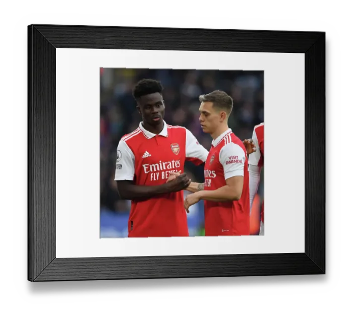 Framed Print : Arsenal's Bukayo Saka and Leandro Trossard Face Off Against Leicester City in the Premier League