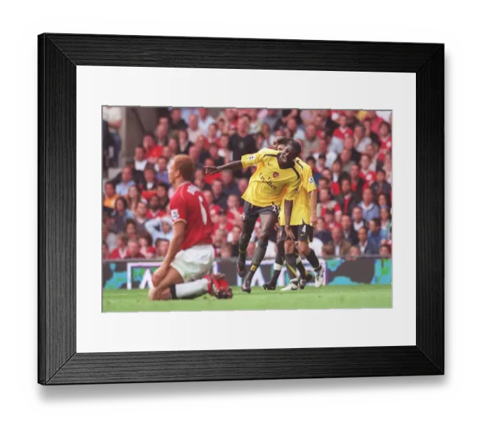 Framed Print : Adebayor's Euphoric Moment: Arsenal's 1-0 Victory Over Manchester United, 2006 Framed Print : Adebayor's Euphoric Moment: Arsenal's 1-0 Victory Over Manchester United, 2006