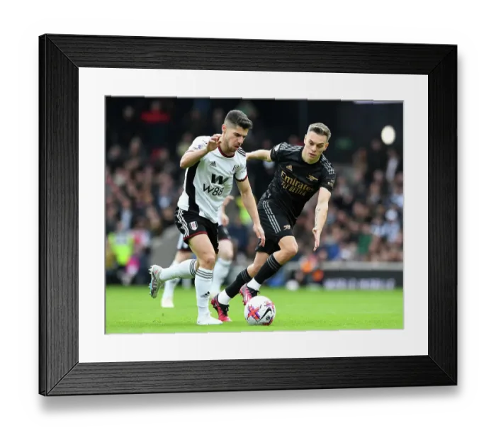 Framed Print : Arsenal's Trossard Closes In on Fulham's Solomon in Premier League Clash