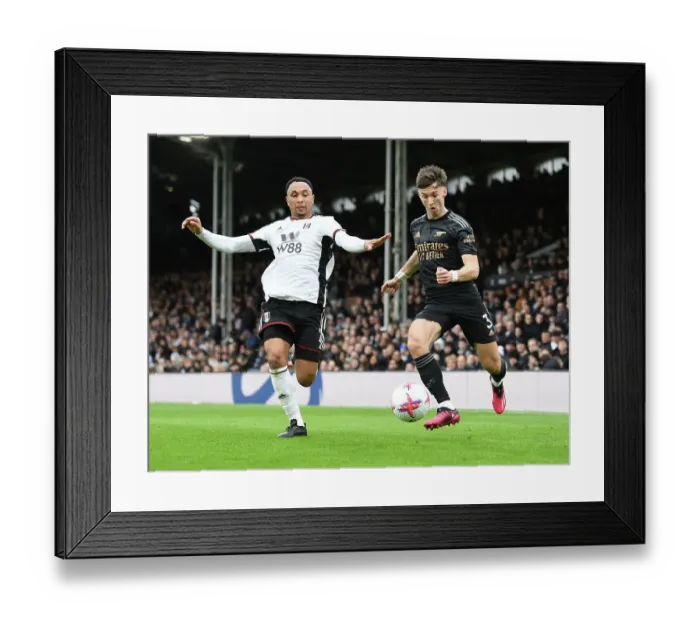 Framed Print : Arsenal's Kieran Tierney Fends Off Fulham's Kenny Tete in Premier League Clash