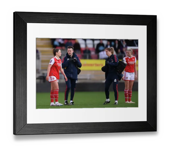 Framed Print : Arsenal's Gio Queiroz Receives Medical Attention During Tottenham vs Arsenal Women's Super League Clash