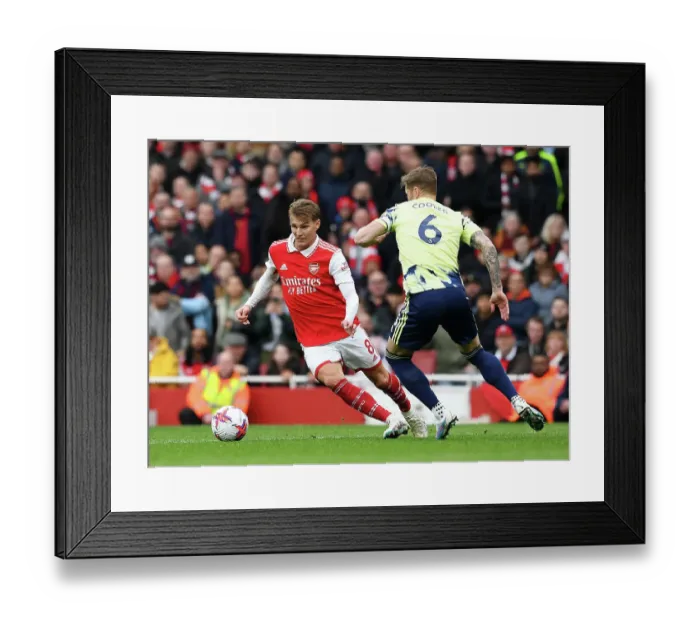 Framed Print : Arsenal's Martin Odegaard Fends Off Leeds United's Liam Cooper: Premier League Clash at Emirates Stadium (April 2023) Framed Print : Arsenal's Martin Odegaard Fends Off Leeds United's Liam Cooper: Premier League Clash at Emirates Stadium (April 2023)